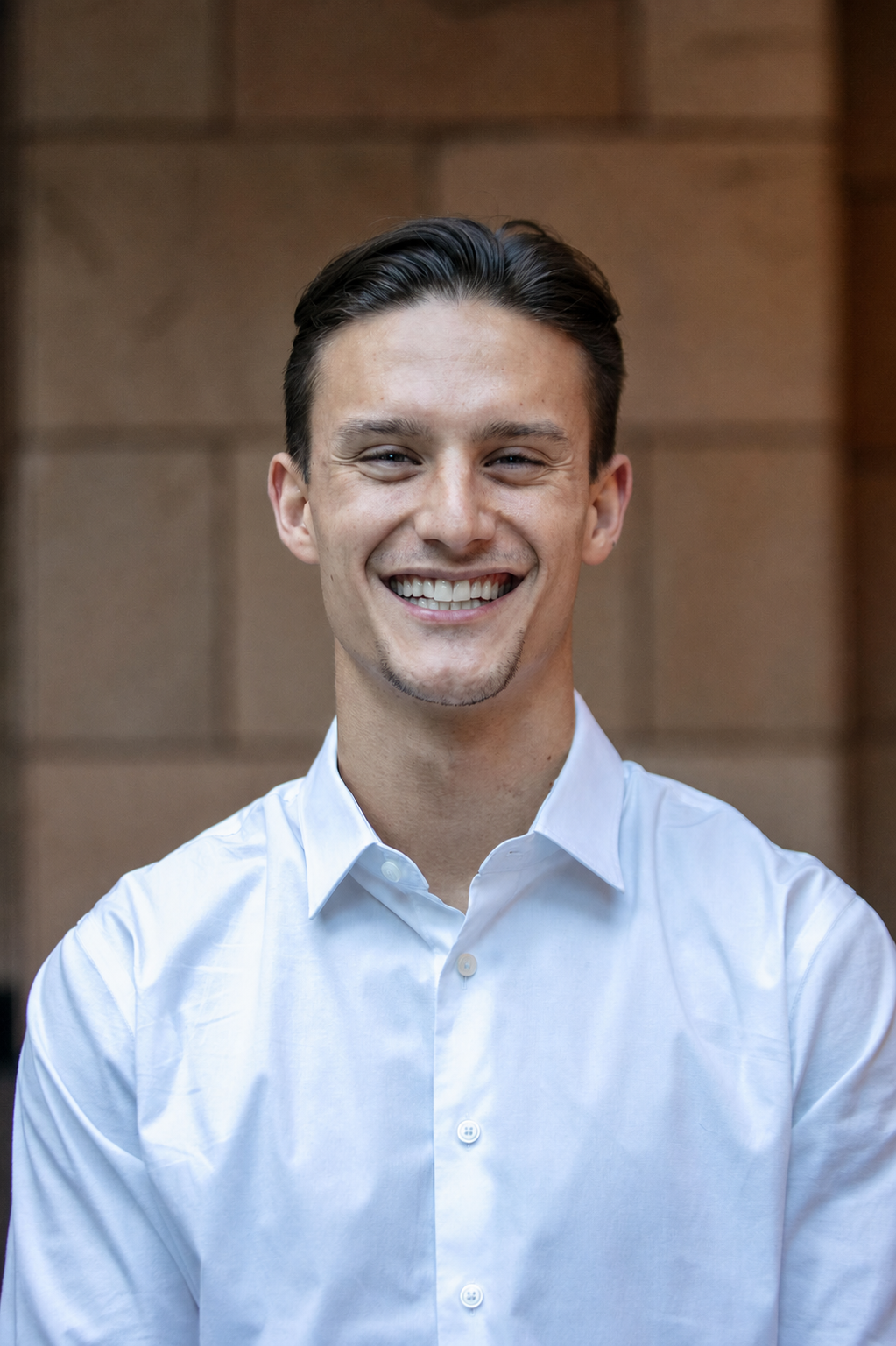 Professional portrait of Teagan Lawrence Jarvis smiling in a white shirt